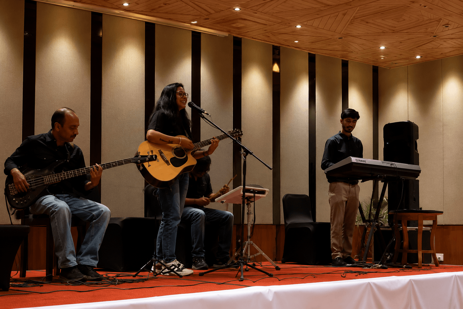 Female event singer performing live music with band during a wedding celebration