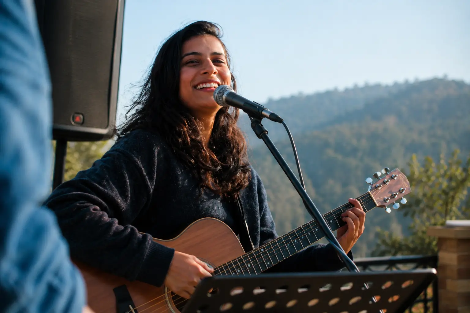 Female live singer performing with guitar at an outdoor event in Kasauli, creating a warm and engaging atmosphere for weddings, private parties, and celebrations.